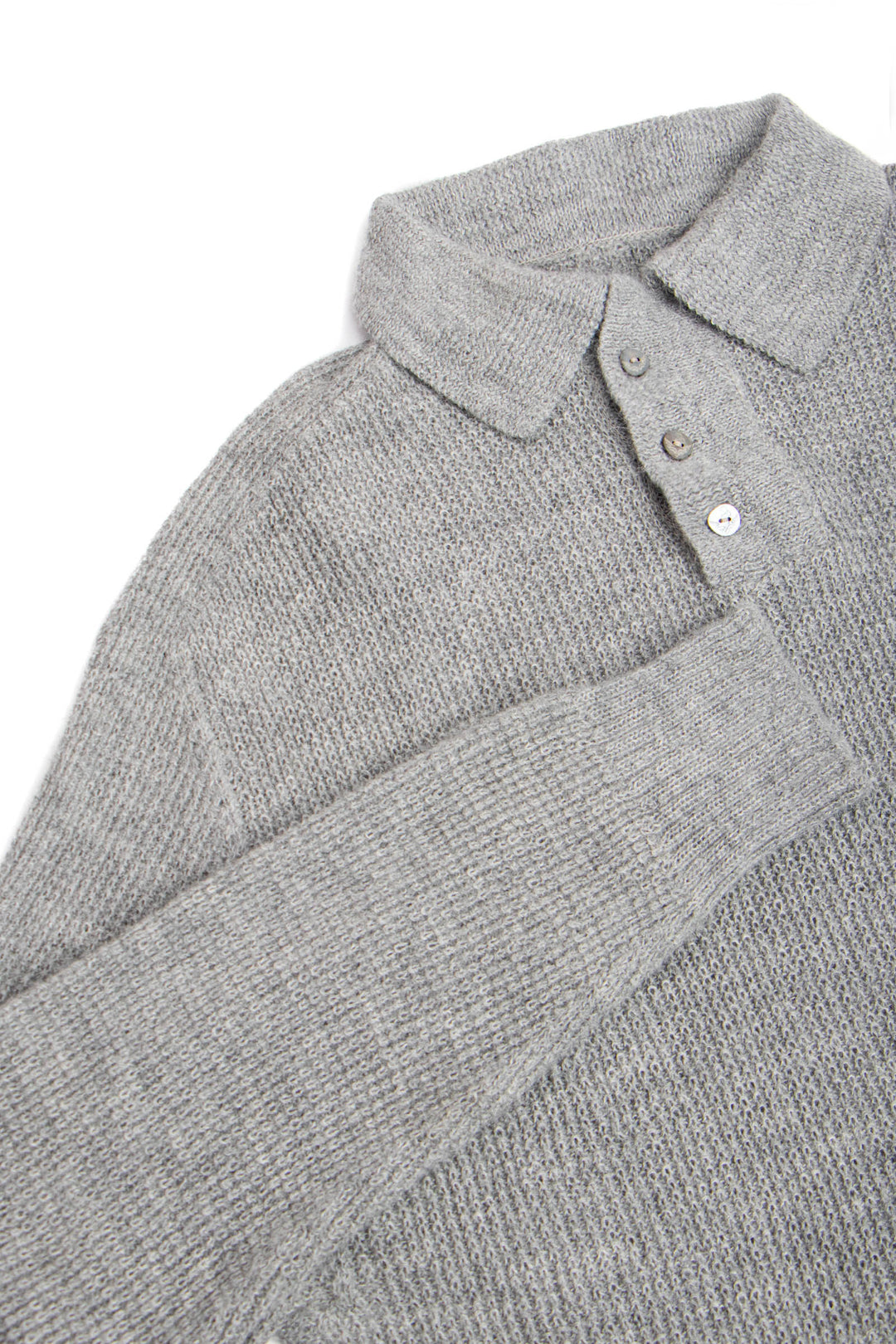 Close-up of a gray knitted sweater with a collar and buttons on a white background #colour_cool-grey